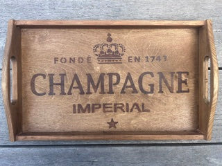 Wooden tray with 'Champagne Imperial' branding on a wooden surface